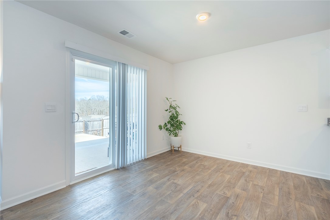 231 Millhone Way Pendleton, SC 29670 - Photo 18 of 32 This bright space features sleek flooring and a large sliding glass door, offering access to outdoor living.