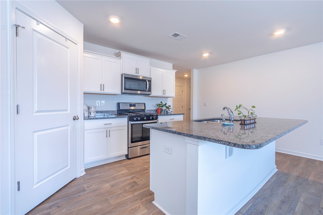 231 Millhone Way Pendleton, SC 29670 - Photo 22 of 32 This bright kitchen features sleek appliances and ample counter space, perfect for culinary endeavors.