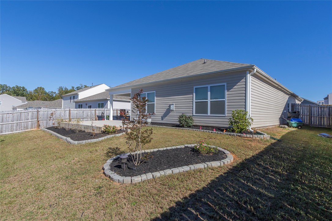 231 Millhone Way Pendleton, SC 29670 - Photo 29 of 32 This property features a fenced backyard with a patio, perfect for outdoor enjoyment.