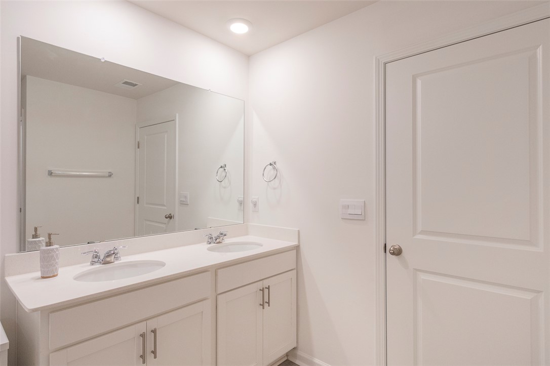 231 Millhone Way Pendleton, SC 29670 - Photo 6 of 32 This spacious bathroom features a double vanity and sleek fixtures for a clean, modern aesthetic.