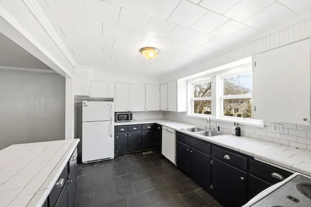 a kitchen with a sink cabinets and window