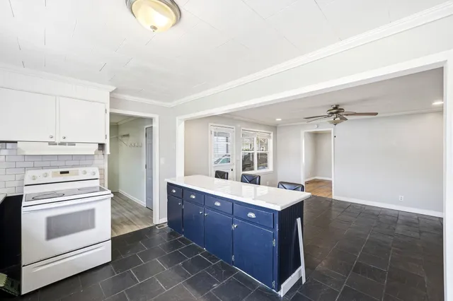 a kitchen with a stove a sink and a refrigerator
