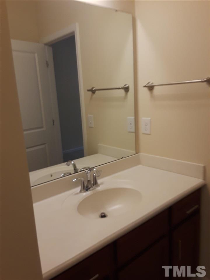 625 Briarcliff Street Apex, NC 27502 - Photo 14 of 18 a bathroom with a sink and a mirror