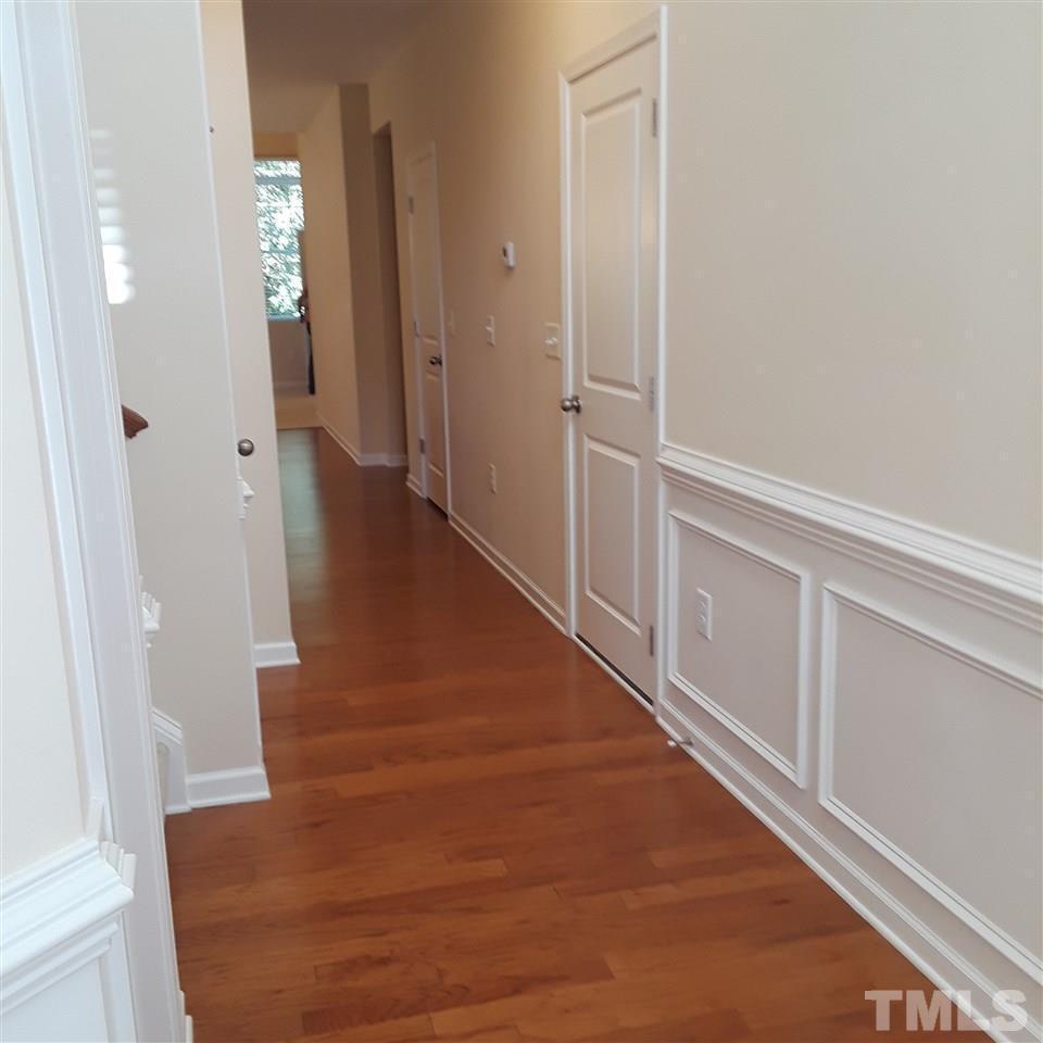 625 Briarcliff Street Apex, NC 27502 - Photo 3 of 18 a view of a hallway with wooden floor and staircase