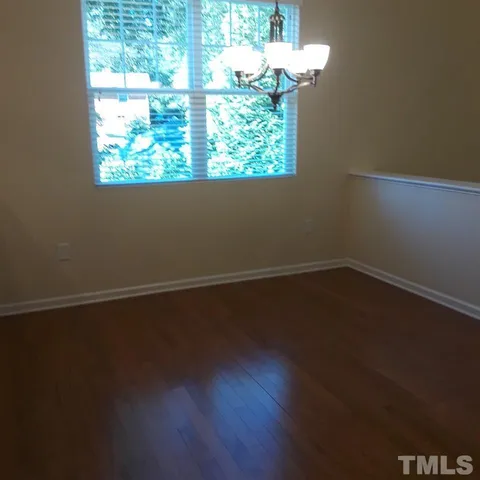 a view of a small space with wooden floor and a window