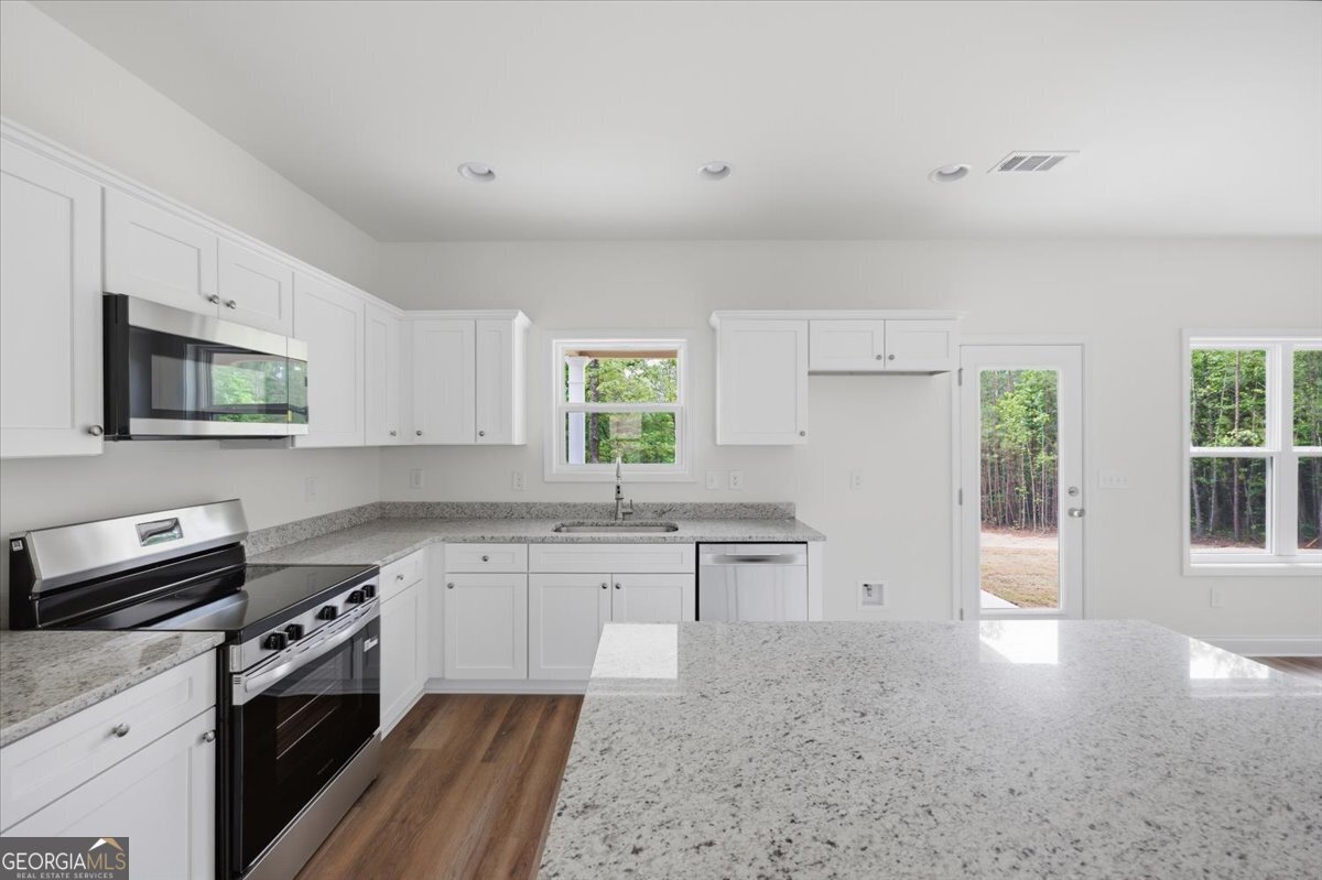 2778 Boxankle Road Forsyth, GA 31029 - Photo 7 of 21 a kitchen with granite countertop a sink stainless steel appliances and cabinets