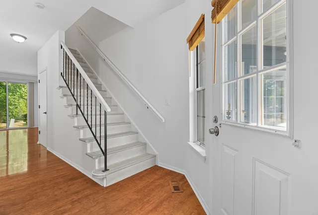 a view of entryway and hall with wooden floor