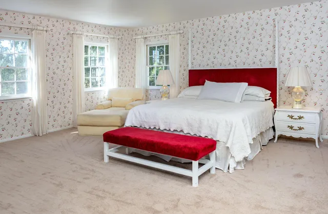 a bathroom with a tub a double vanity sink and mirror