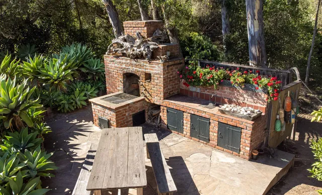 a front view of house with a garden