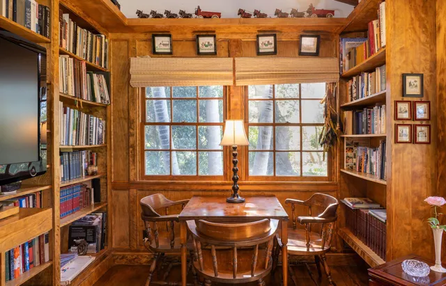 a view of a dining room with furniture and a book shelf