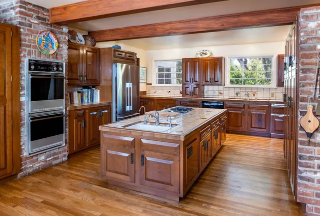 a kitchen with stainless steel appliances granite countertop a stove and a refrigerator
