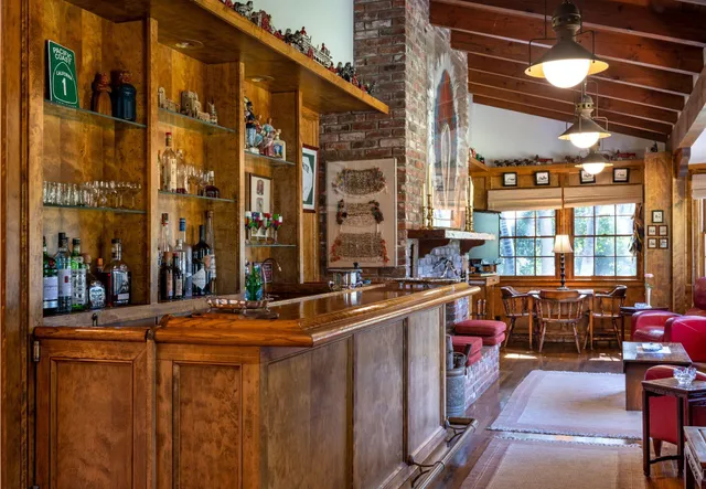 a dining room with furniture a chandelier and wooden floor