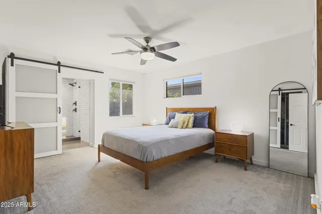 a bedroom with a bed dresser and a window