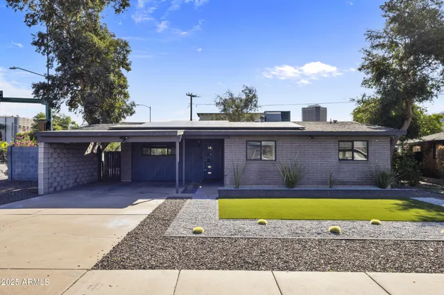 a view of a house with swimming pool in front of it