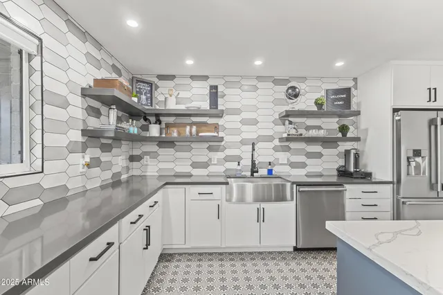 a kitchen with stainless steel appliances granite countertop a sink and cabinets