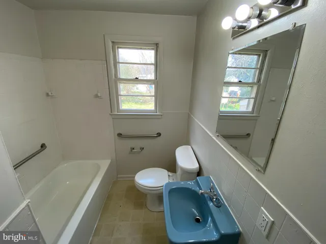 a bathroom with a sink a toilet and bathtub