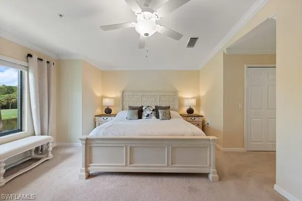 a spacious bedroom with a bed and a window