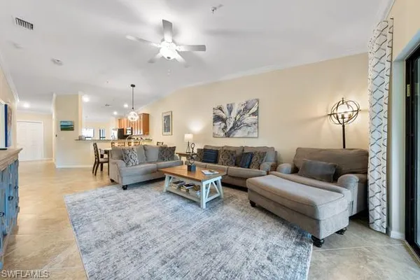 a living room with furniture and a chandelier