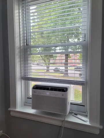 a white toilet sitting next to a bath tub