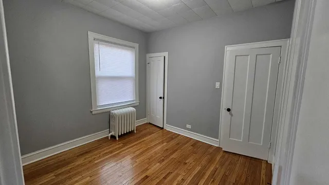 a bedroom with a bed and a mirror