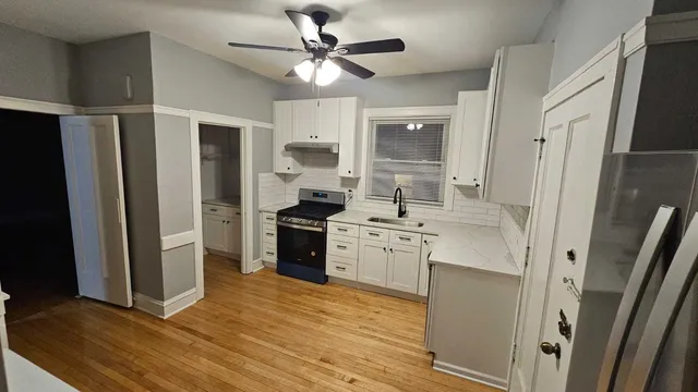 wooden floor in an empty room with a fireplace