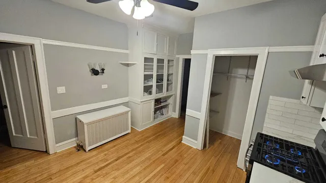 a kitchen with stainless steel appliances a refrigerator a sink and wooden floors