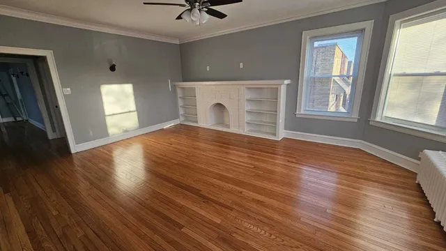 a view of livingroom with hardwood floor and a ceiling fan