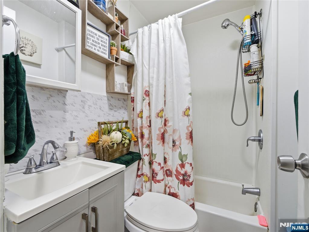 31 Dover Street Paterson, NJ 07501 - Photo 6 of 12 a bathroom with a sink toilet and shower