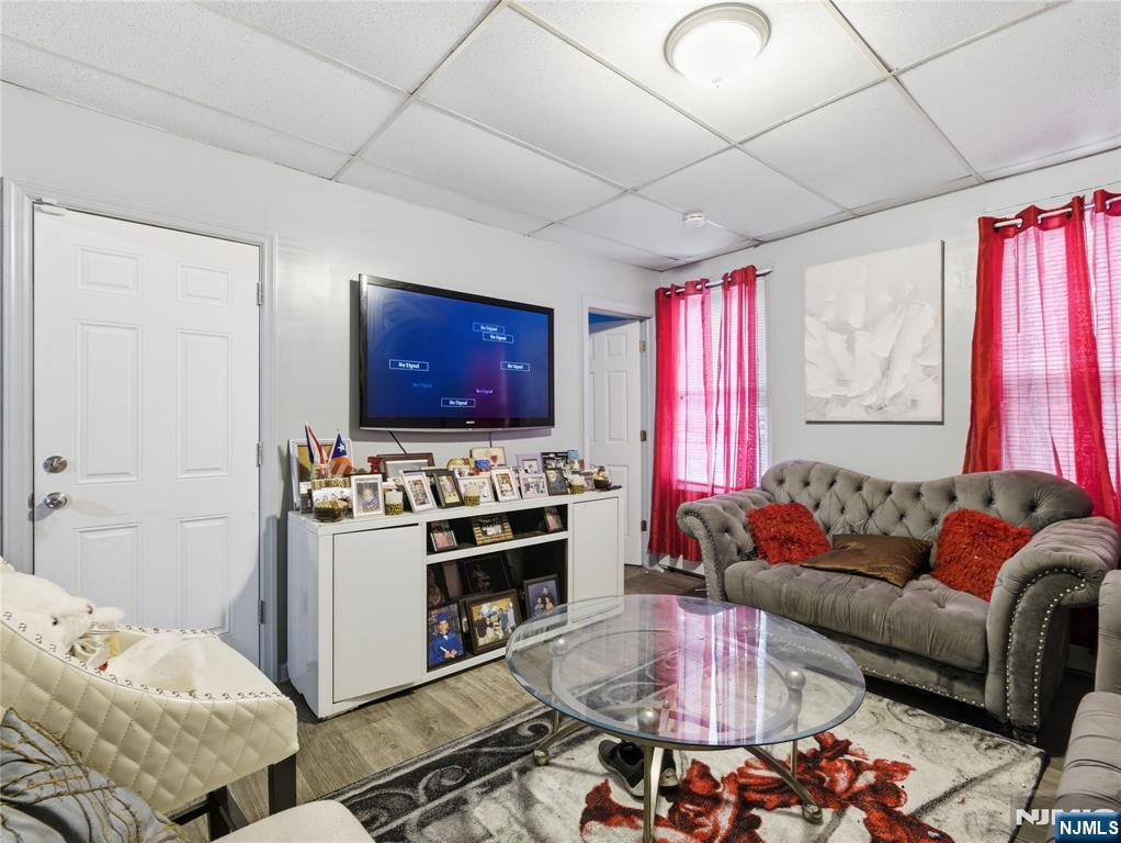 31 Dover Street Paterson, NJ 07501 - Photo 7 of 12 a living room with furniture and a flat screen tv