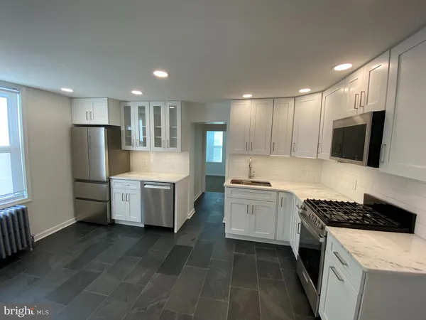 a kitchen with a sink stove and refrigerator