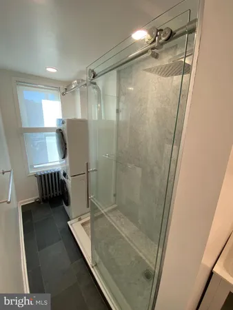 a bathroom with a shower and a sink