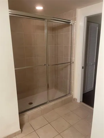 a bathroom with a glass shower door