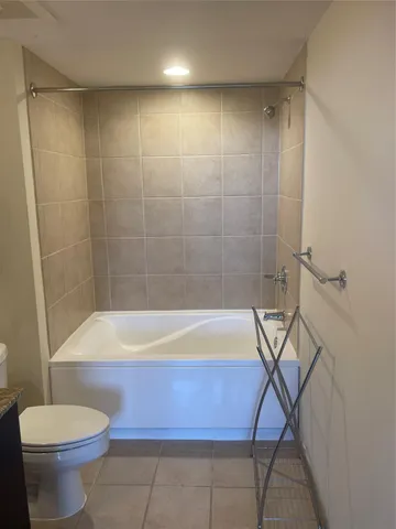 a bathroom with a bathtub and a toilet