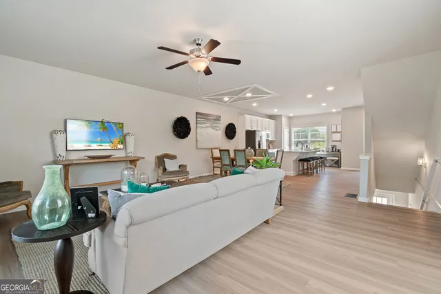 a living room with furniture and a wooden floor