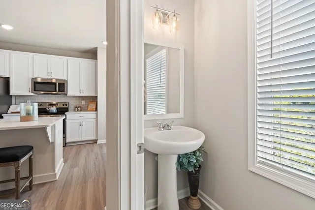 a kitchen with a sink cabinets and a window
