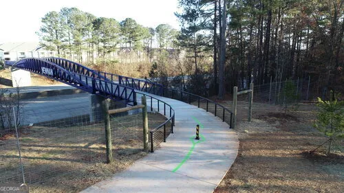 a view of a pathway with a yard of the house