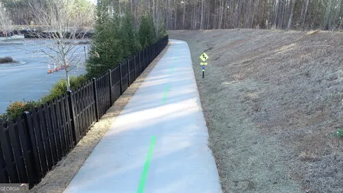 a view of a pathway with a wooden fence