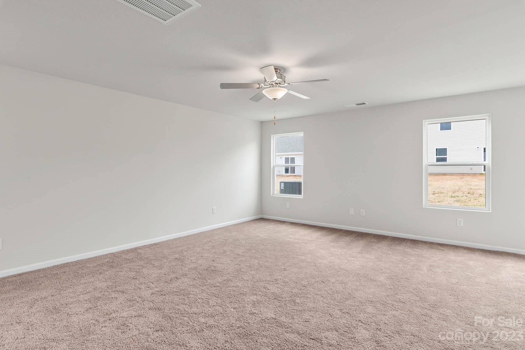 1518 Nia Road Charlotte, NC 28215 - Photo 3 of 14 an empty room with windows and fan