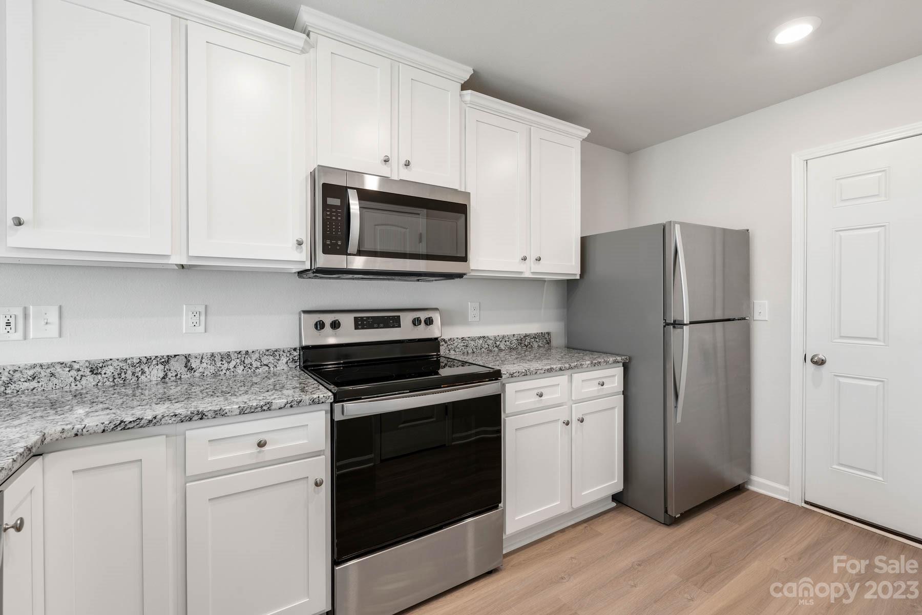 1518 Nia Road Charlotte, NC 28215 - Photo 8 of 14 a kitchen with cabinets stainless steel appliances and a counter space