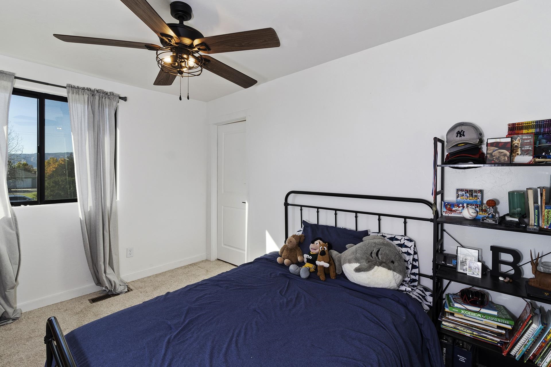 1874 L Road Fruita, CO 81521 - Photo 25 of 42 a bedroom with bed and a chandelier