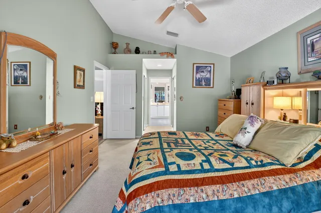 a view of a bedroom with workspace and a window