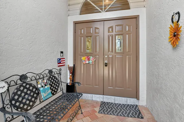a view of a livingroom with wooden floor and a refrigerator