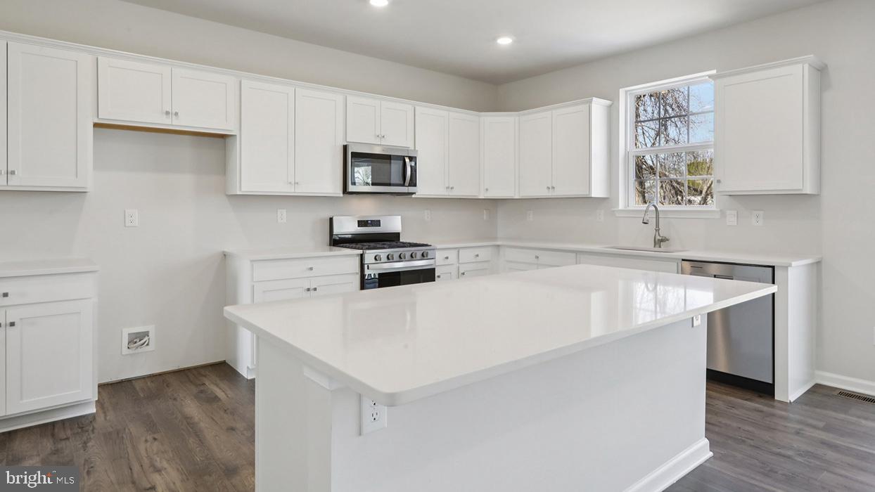 120 Winding Road Easton, PA 18040 - Photo 27 of 80 a kitchen with stainless steel appliances a white stove top oven sink and cabinets