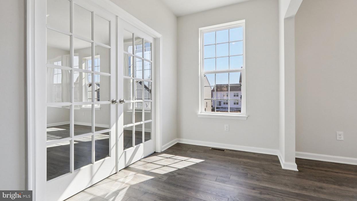 120 Winding Road Easton, PA 18040 - Photo 42 of 80 a view of an empty room with wooden floor and windows