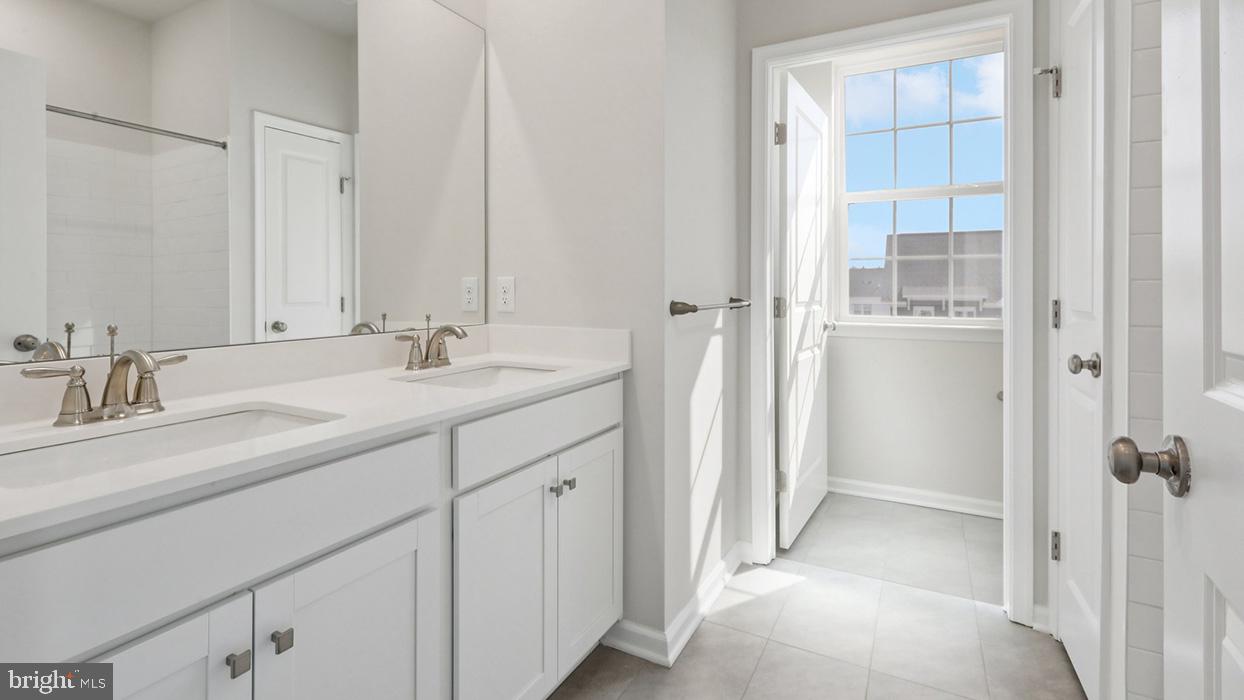 120 Winding Road Easton, PA 18040 - Photo 62 of 80 a bathroom with a double vanity sink a mirror and a shower