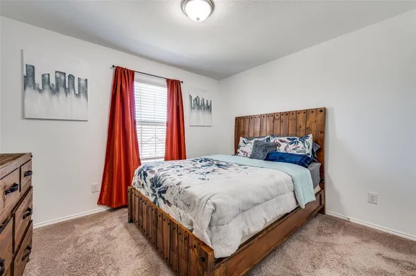 a bed sitting in a bedroom next to a window