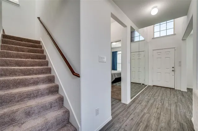 a view of entryway with wooden floor and stairs