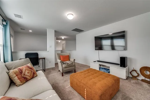 a bedroom with furniture and a flat screen tv