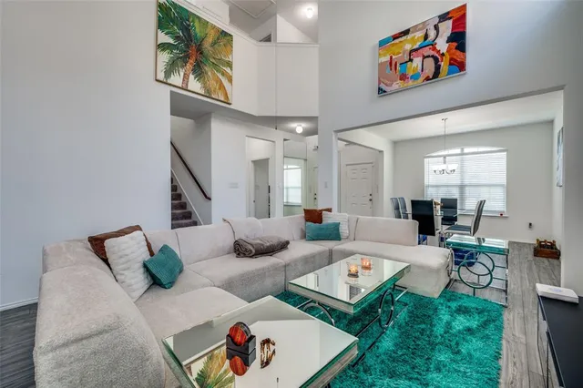 a living room with furniture and painting on the wall