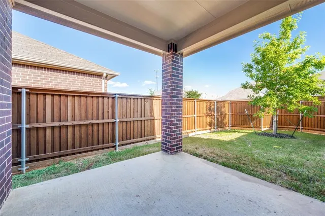 a view of a backyard with wooden fence